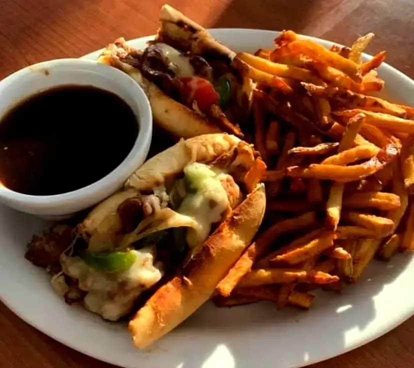 Philly cheese steak sandwich, fries on the side